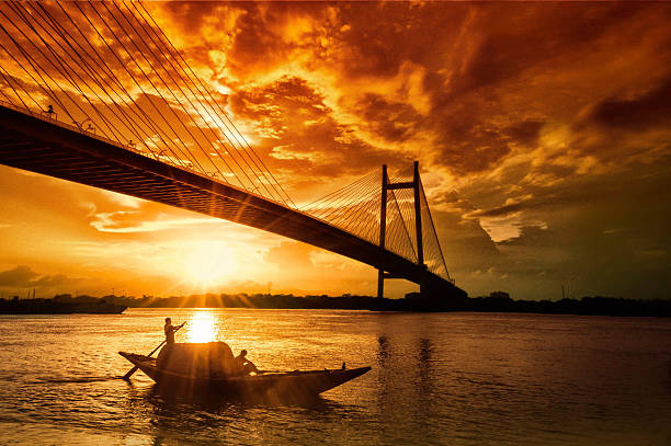 The view of hugli bridge captured from princep ghat and a boat during the sunset. Image credit- Cultural Kaleidoscope.
